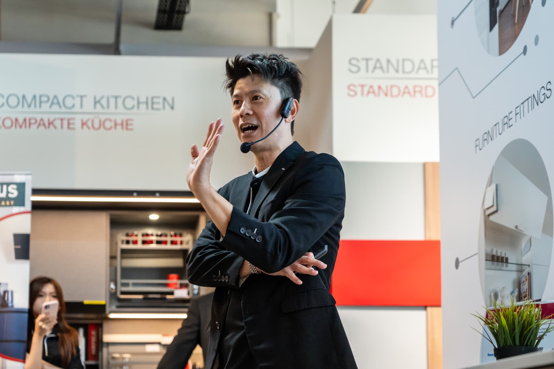 Russell Chin speaking with a headset microphone at a live renovation talk