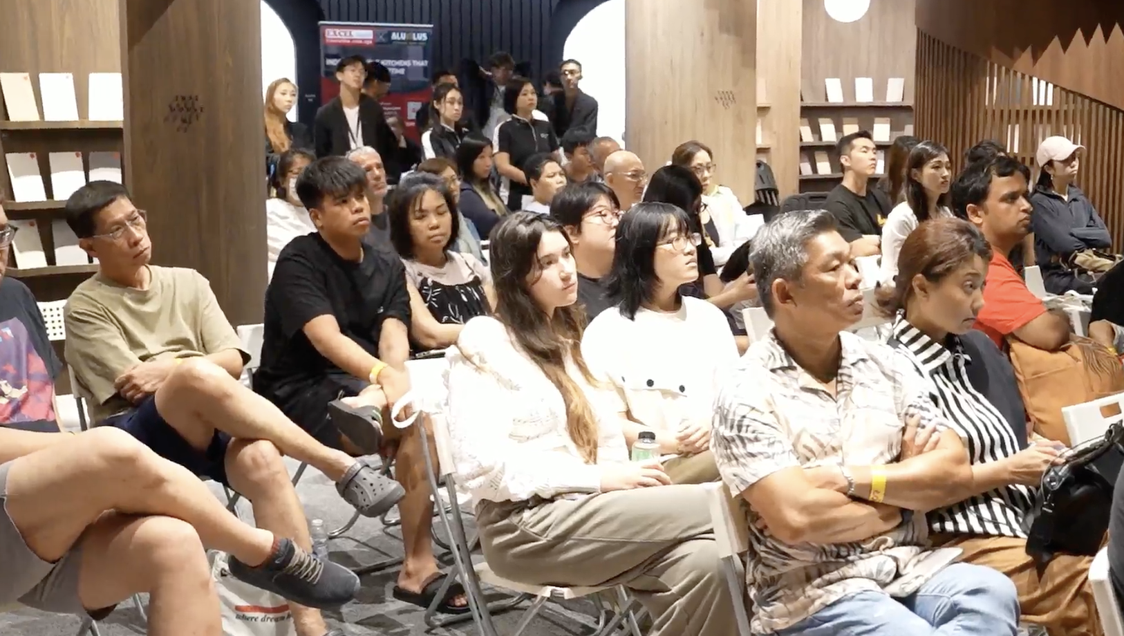 Homeowners seated and listening intently during a renovation talk