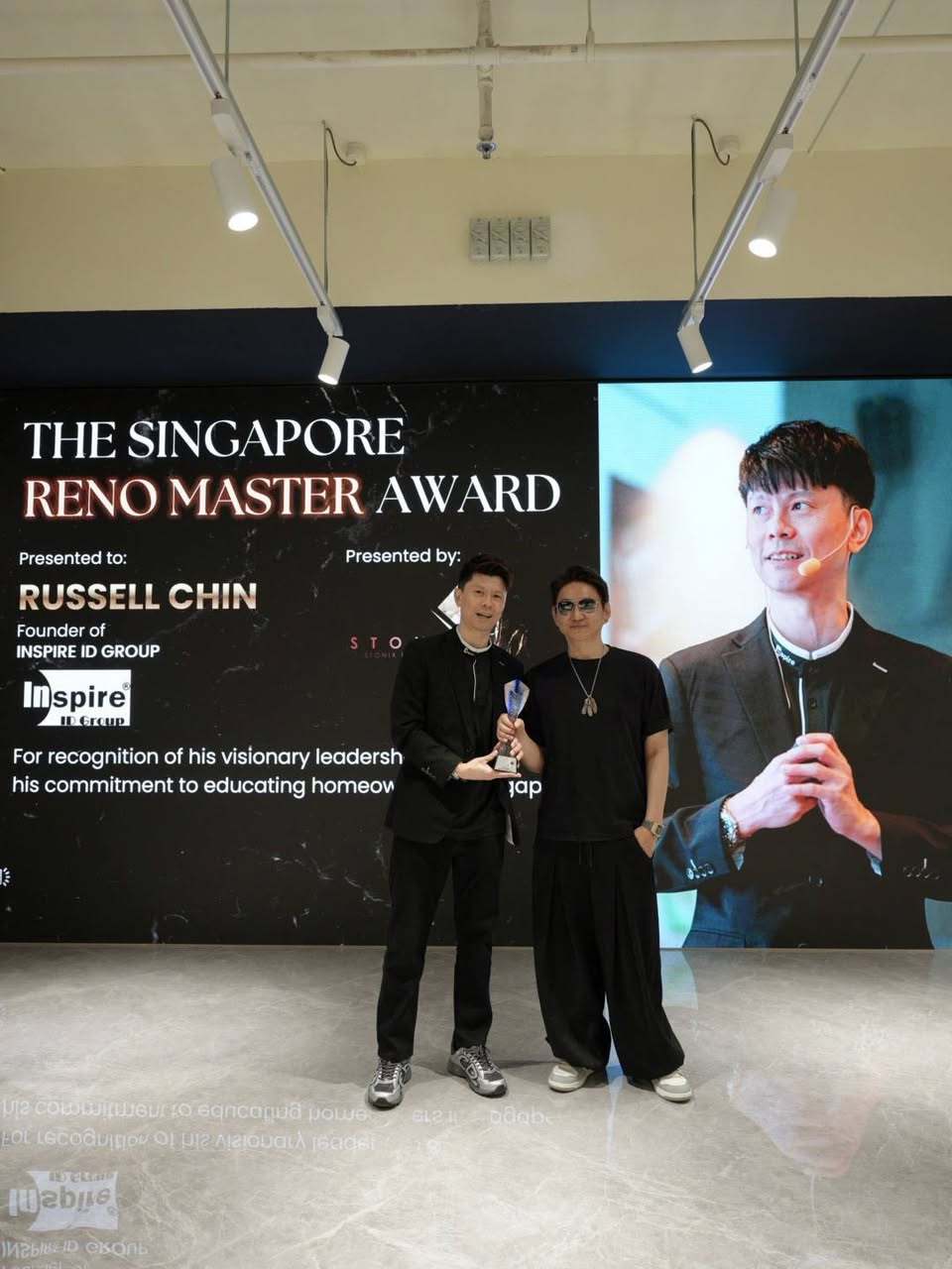Russell Chin receiving The Singapore Reno Master Award on stage