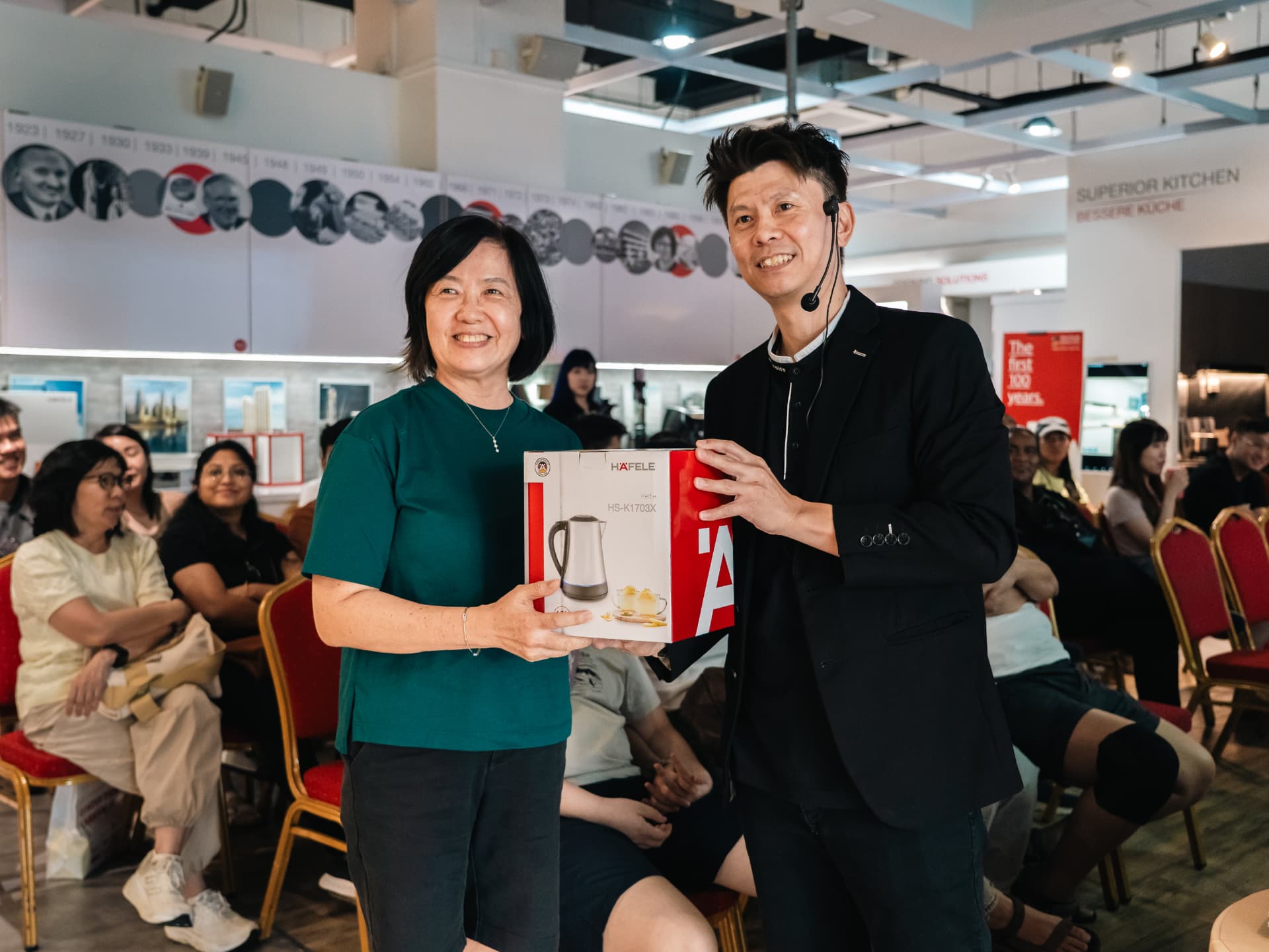 A homeowner receiving a Häfele glass kettle from Russell Chin